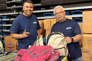 Volunteers with donated backpacks